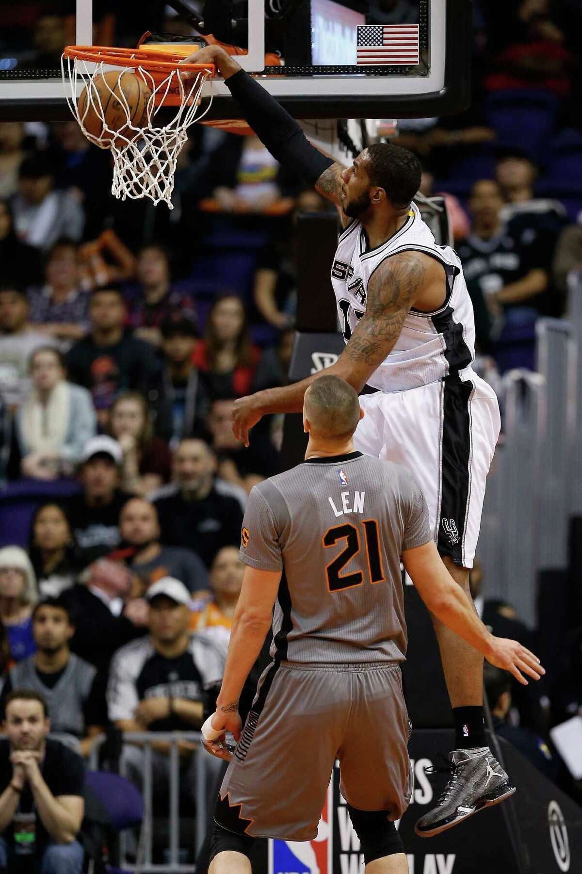 PHOENIX, AZ - JANUARY 21: LaMarcus Aldridge #12 of the San Antonio Spurs slam dunks against the Phoenix Suns during the first half of the NBA game at Talking Stick Resort Arena on January 21, 2016 in Phoenix, Arizona. NOTE TO USER: User expressly acknowledges and agrees that, by downloading and or using this photograph, User is consenting to the terms and conditions of the Getty Images License Agreement.