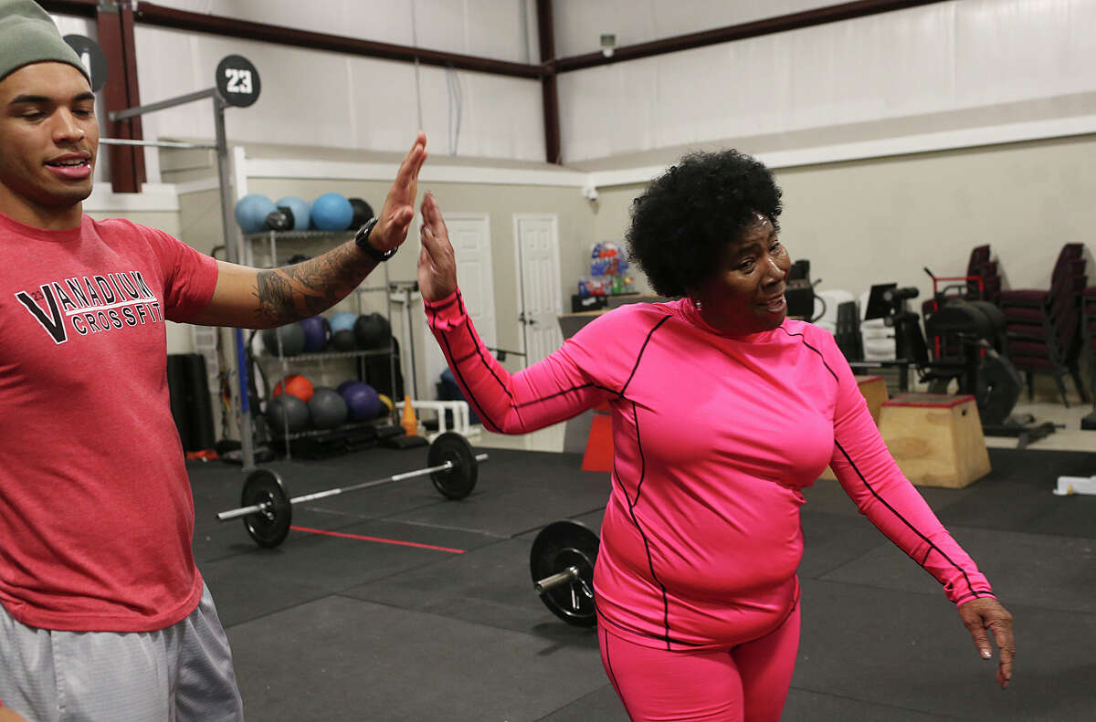 Fran Vega, 64, high fives trainer Shyrell Shaw, 21, after she finished a set of deadlifts during a crossfit program for seniors at The Get Up Community Center, Thursday, Jan. 7, 2016,
