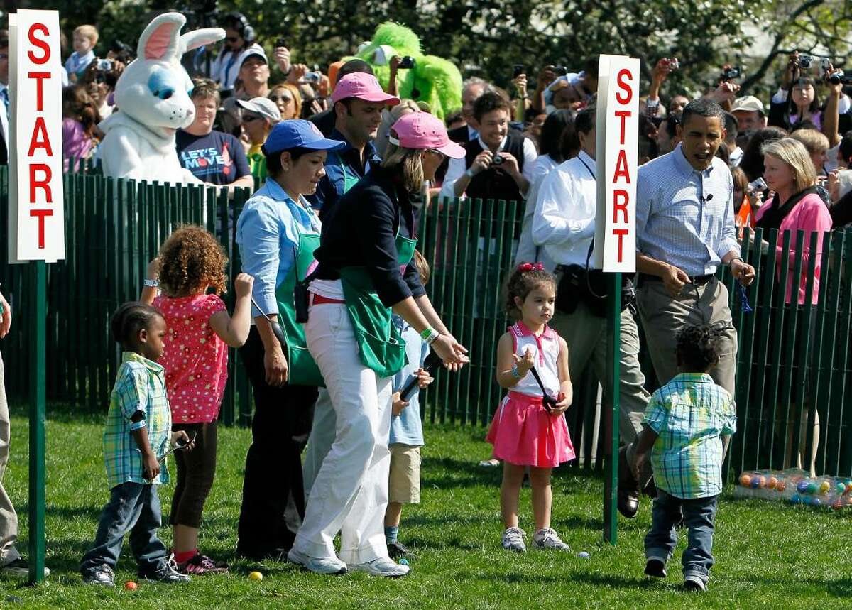 WASHINGTON - APRIL 05: U.S. President Barack Obama (R) interacts with children during the annual White House Easter Egg Roll at the South Lawn April 5, 2010 in Washington, DC. The White House Easter Egg Roll is a tradition dating back to 1878 during the presidency of President Rutherford B. Hayes. (Photo by Alex Wong/Getty Images) *** Local Caption *** Barack Obama