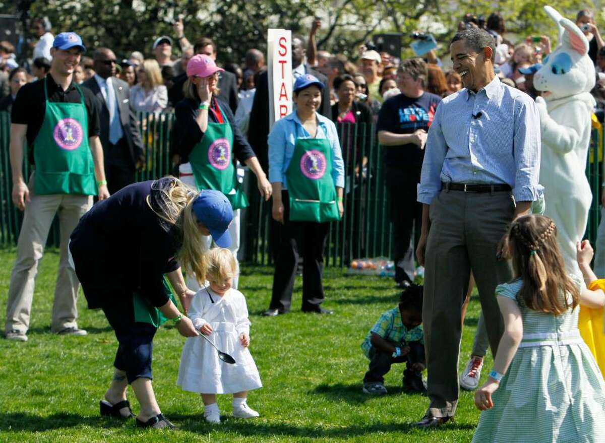 WASHINGTON - APRIL 05: U.S. President Barack Obama (R) watches as children participate during the annual White House Easter Egg Roll at the South Lawn April 5, 2010 in Washington, DC. The White House Easter Egg Roll is a tradition dating back to 1878 during the presidency of President Rutherford B. Hayes. (Photo by Alex Wong/Getty Images) *** Local Caption *** Barack Obama