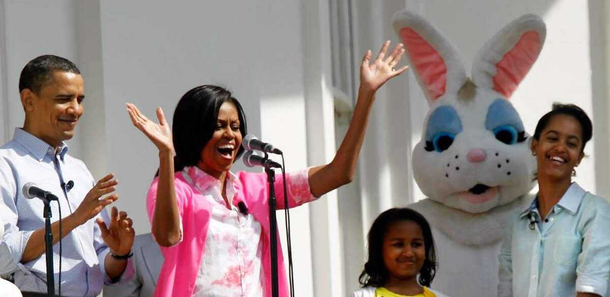 WASHINGTON - APRIL 05: U.S. first lady Michelle Obama (2nd L) speaks from the Truman Balcony as President Barack Obama (L), daughters Malia (R) and Sasha (3rd L) look on during the annual White House Easter Egg Roll at the South Lawn April 5, 2010 in Washington, DC. The White House Easter Egg Roll is a tradition dating back to 1878 during the presidency of President Rutherford B. Hayes. (Photo by Alex Wong/Getty Images) *** Local Caption *** Barack Obama;Michelle Obama;Malia Obama;Sasha Obama