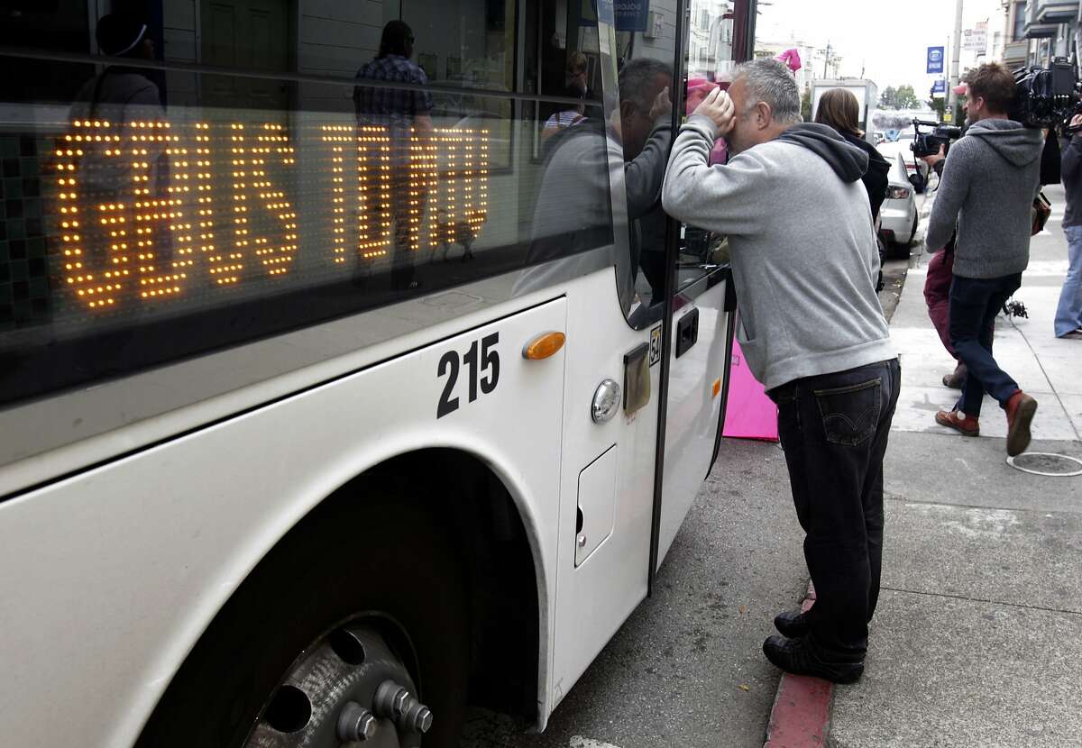 Protesters, angered by the high number of Ellis Act evictions on tenants, move in to block a Google bus at 18th and Dolores streets in San Francisco, Calif. on Friday, April 11, 2014.