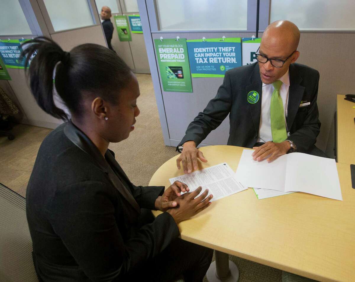 Tax preparer Richard Sowell (right) works with Courtney Mayhew at H&R Block offices in Atlas District in Washington.