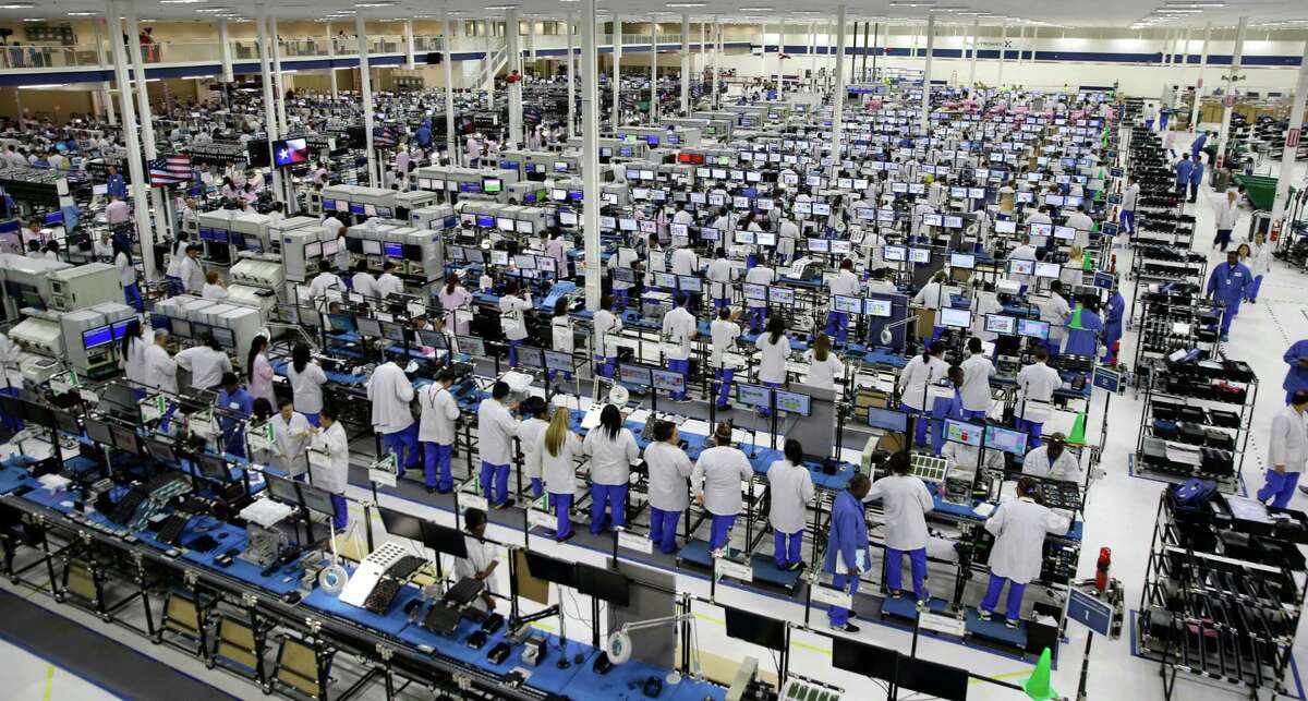 FILE -In this Tuesday, Sept. 10, 2013, file photo, workers man the Motorola smartphone plant in Fort Worth, Texas. Economists forecast that U.S. industrial production dipped 0.1 percent in November 2015, according to the data firm FactSet. That would be the third straight monthly drop. The report is scheduled for release, Wednesday, Dec. 16, 2015. (AP Photo/LM Otero, File)