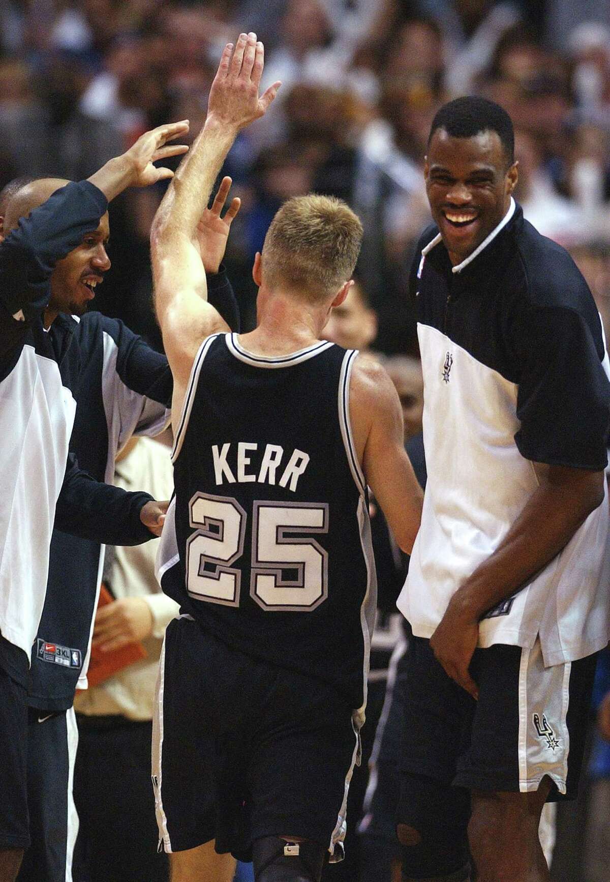San Antonio Spurs players Steve Kerr, right, Danny Ferry (35), Kevin  Willis, rear, and trainer Will Sevening celebrate their 88-77 win over the  New Jersey Nets for the NBA Championship, Sunday, June