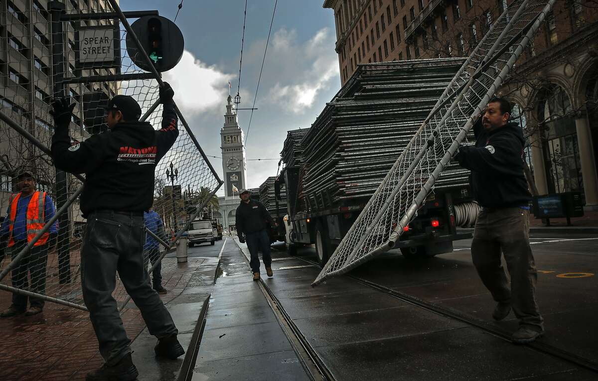 Crews line Market St. and the blocks surrounding Superbowl City with portable fencing at the foot of Market St., on Sat. January 23, 2016, in San Francisco , Calif., as the city prepares for the big event.