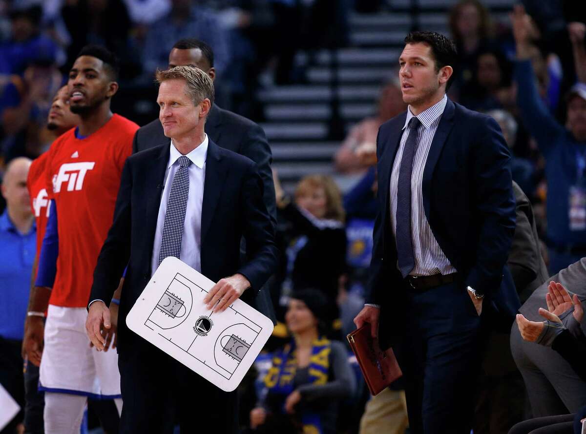 OAKLAND, CA - JANUARY 22: Head coach Steve Kerr of the Golden State Warriors and assistant coach Luke Walton stands for a time out during their game against the Indiana Pacers at ORACLE Arena on January 22, 2016 in Oakland, California. This is Kerr's first game of the season. NOTE TO USER: User expressly acknowledges and agrees that, by downloading and or using this photograph, User is consenting to the terms and conditions of the Getty Images License Agreement. (Photo by Ezra Shaw/Getty Images)