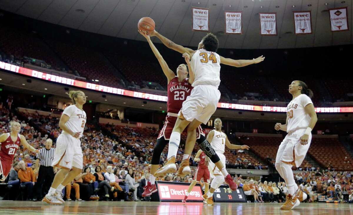 Oklahoma guard Maddie Manning (23) is blocked by Texas center Imani Boyette (34) as she drives to the basket during the second half of an NCAA college basketball game, Saturday, Jan. 23, 2016, in Austin, Texas. Texas won 83-76.(AP Photo/Eric Gay)