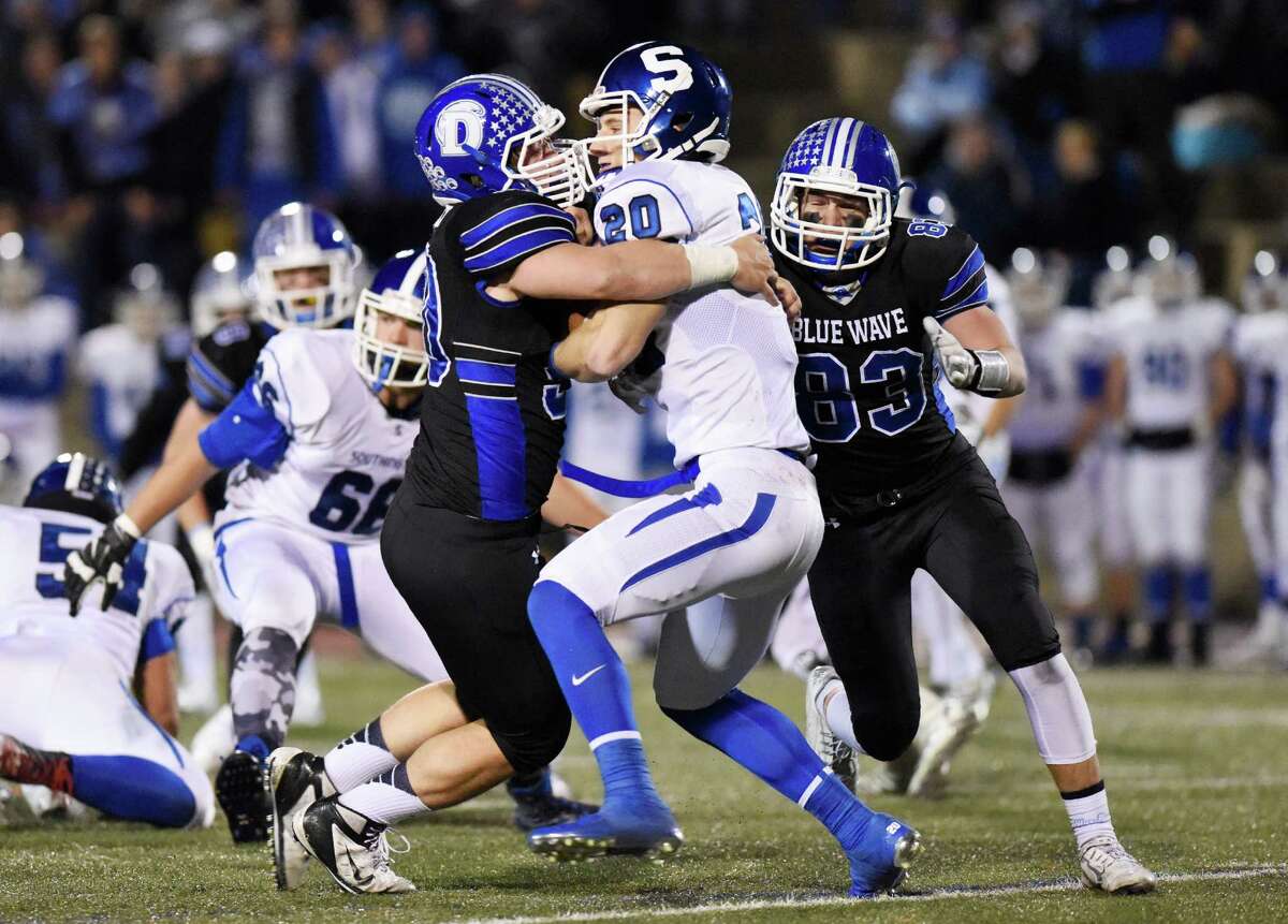 Darien defensive end Mark Evanchick (90) and teammate Quinlin Fay (83) take down Southington quarterback Jasen Rose (20) in the CIAC high school football tournament semifinal game between No. 2 Darien and No. 3 Southington at Boyle Stadium in Stamford, Conn. Monday, Dec. 7, 2015.