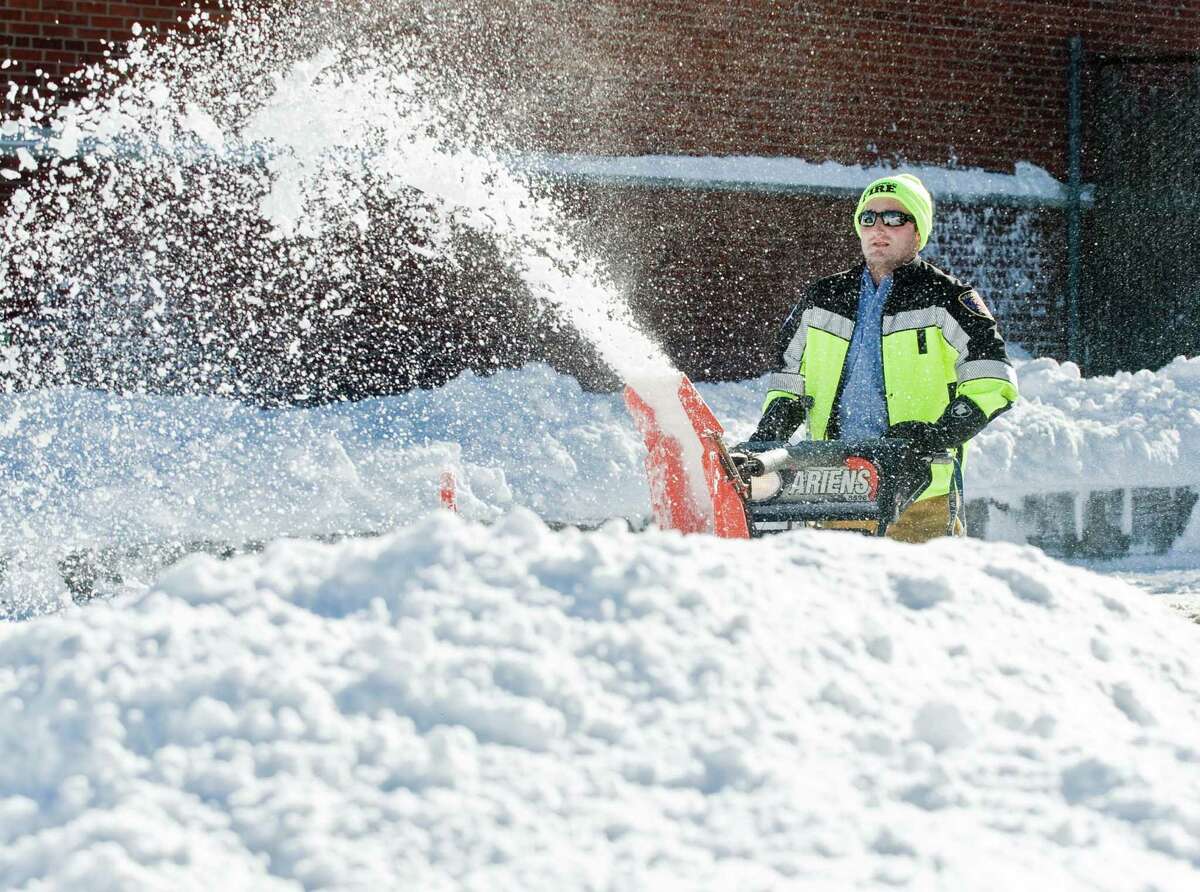 Ridgefield career firefighter Nick Paproski clears the fire department parking lot. Sunday, Jan. 24, 2016
