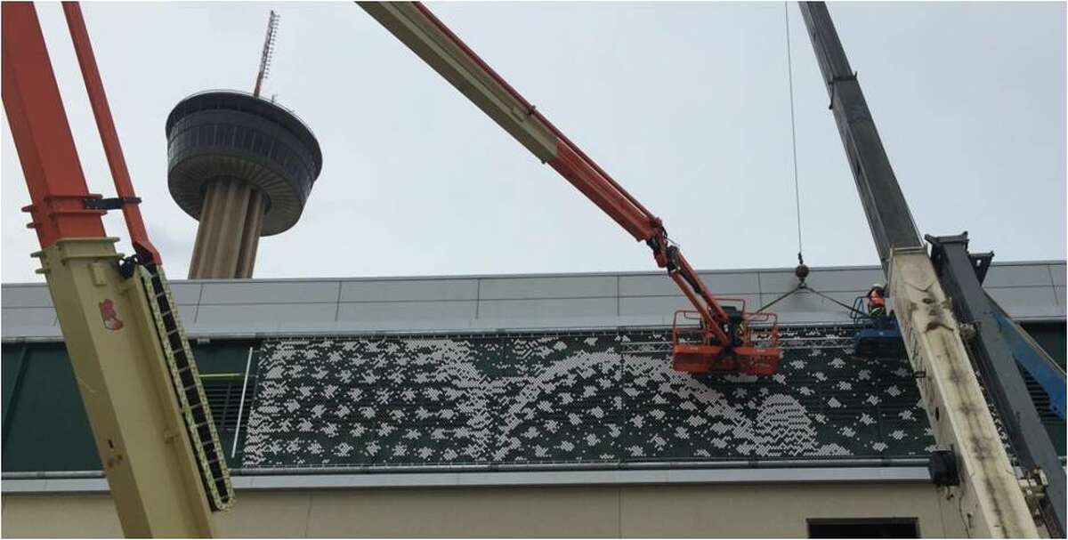 Workers install "Cactus" by Christian Moeller