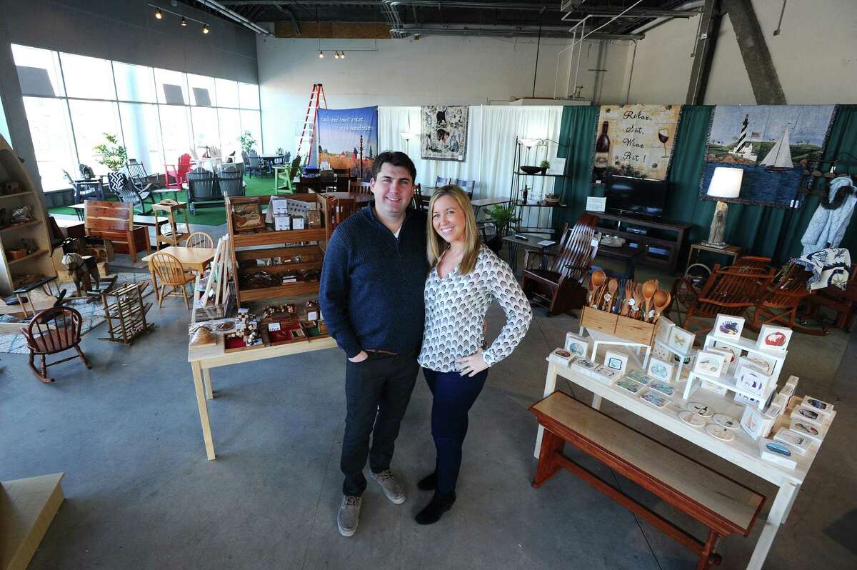 Chris and Beth Meier, owners of Harbor Point's newest retailer Against the Grain, pose for a photo inside of their store that sells handcrafted wood goods made in Amish country on Thursday, Jan. 21, 2016.