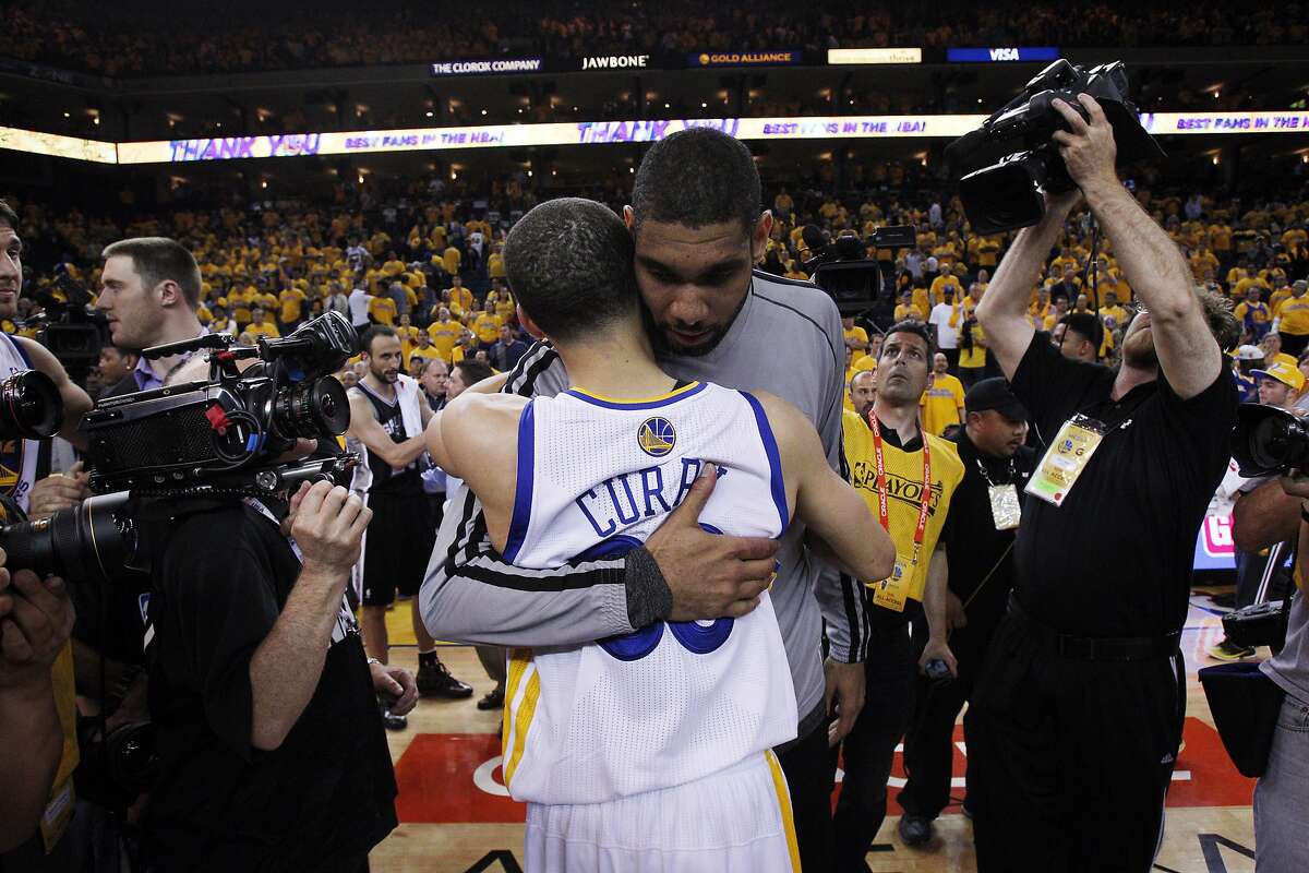 Stephen Curry (30) hugs Tim Duncan after the Warriors lost to the Spurs 94-82. The Golden State Warriors played the San Antonio Spurs in Game 6 of the Western Conference Semifinals at Oracle Arena in Oakland, Calif., on Thursday, May 16, 2013.