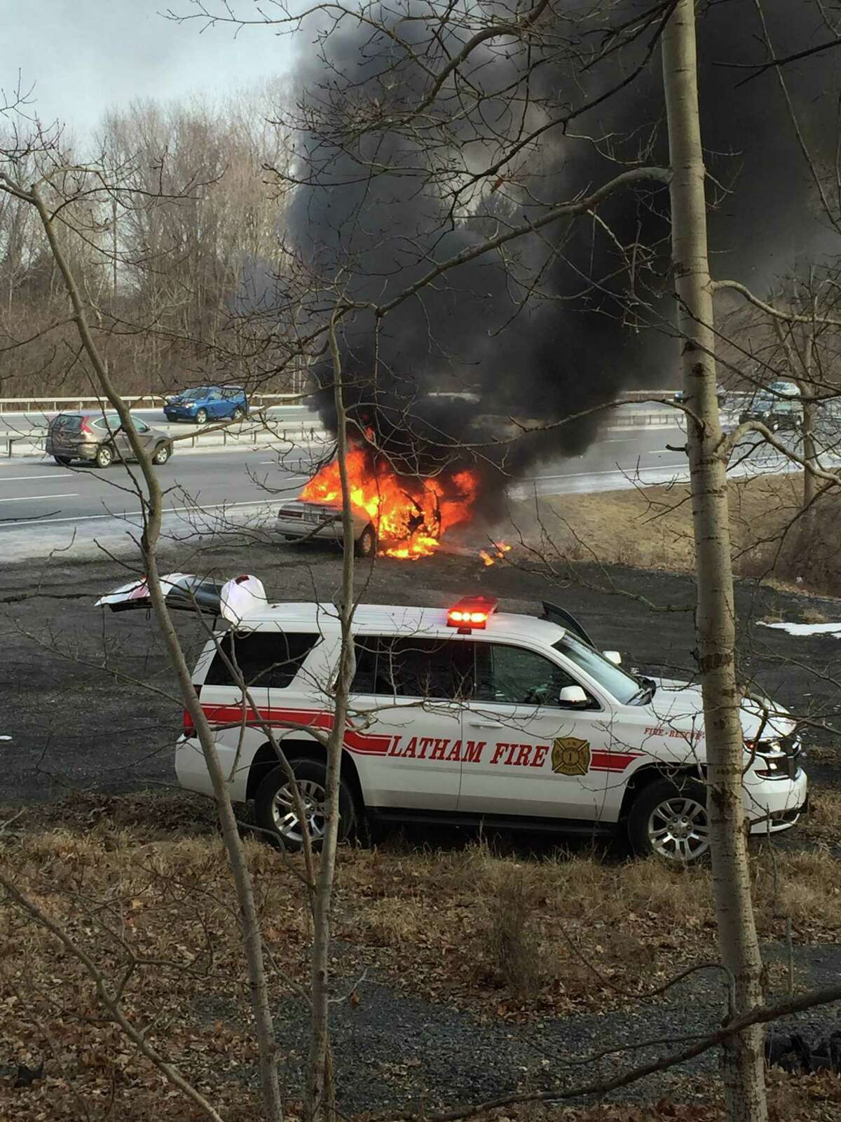 Latham firefighters respond to a car fire Jan. 25, 2016, just south of the Twin Bridges on the Northway. (Sydney Weiskopf)