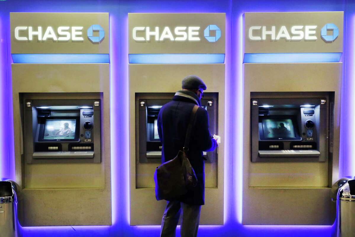 A customer uses an ATM at a branch of Chase Bank in New York. The company will introduce later in 2016 new ATMs that will abandon the need for a card.