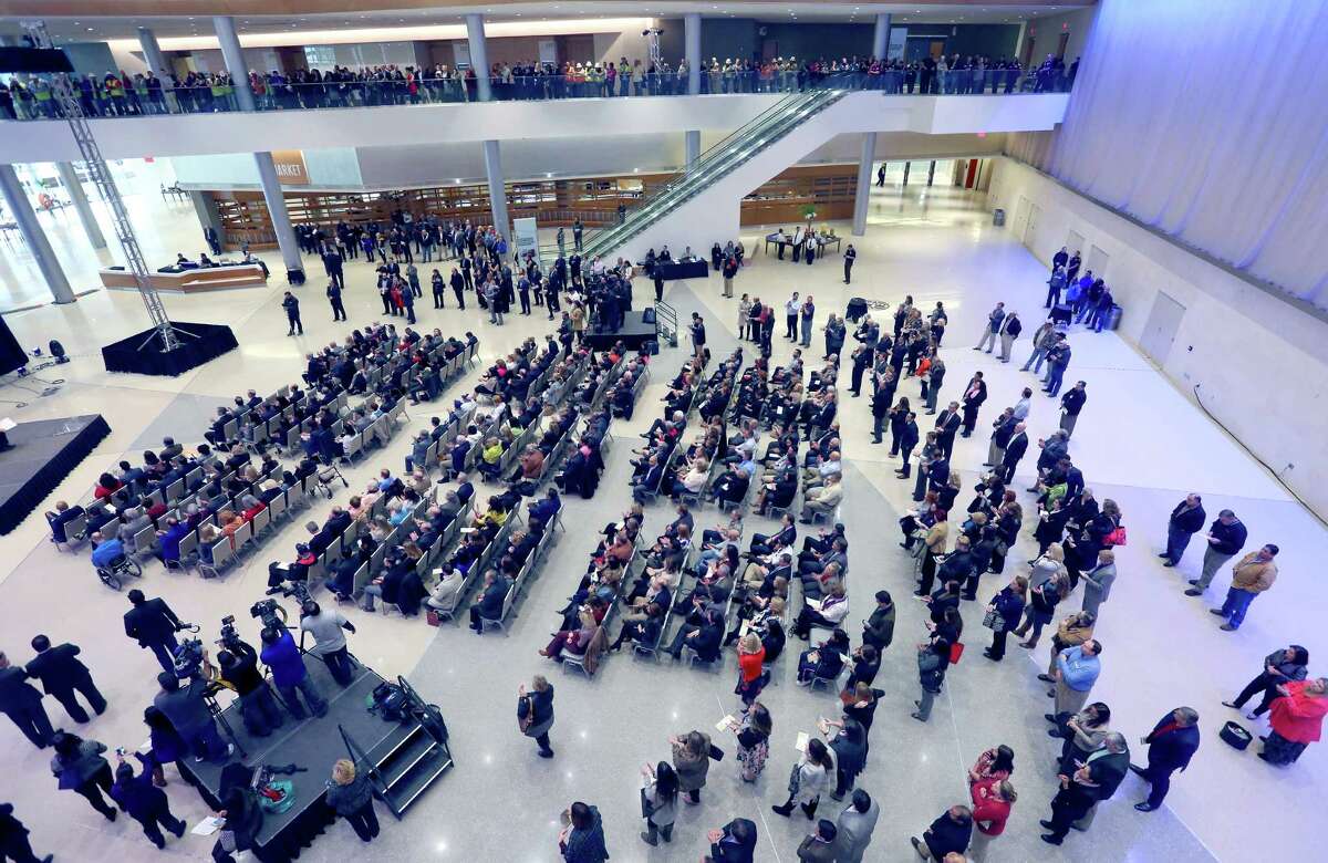 Attendees fill the floor Tuesday, Jan. 26, 2016 of the newly expanded Henry B. Gonzalez Convention Center for the unveiling of the $1 million "Liquid Crystal" art installation. The installation is an interactive sculptural tower created by London-based Jason Bruges Studio.