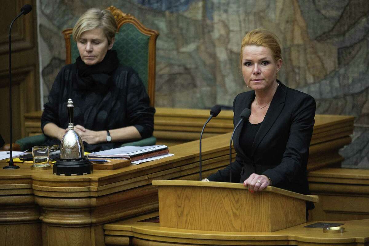 Minister of Integration from the Liberal Party Inger Stoejberg, right, and Mette Bock attend Parliament, in Copenhagen on Tuesday Jan. 26, 2016. Denmark's Parliament is expected to vote allow police seizing valuables worth more than $1,500 from asylum-seekers to help cover their housing and food costs while their cases were being processed. (Peter Hove Olesen/ POLFOTO via AP) DENMARK OUT