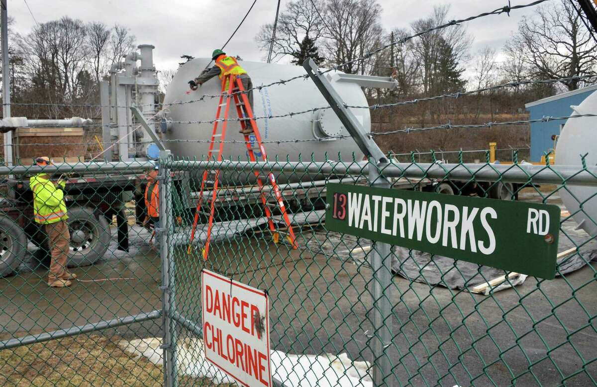 Workers take delivery of a temporary water treatment system Tuesday Jan. 26, 2016 in Hoosick Falls, NY. (John Carl D'Annibale / Times Union)