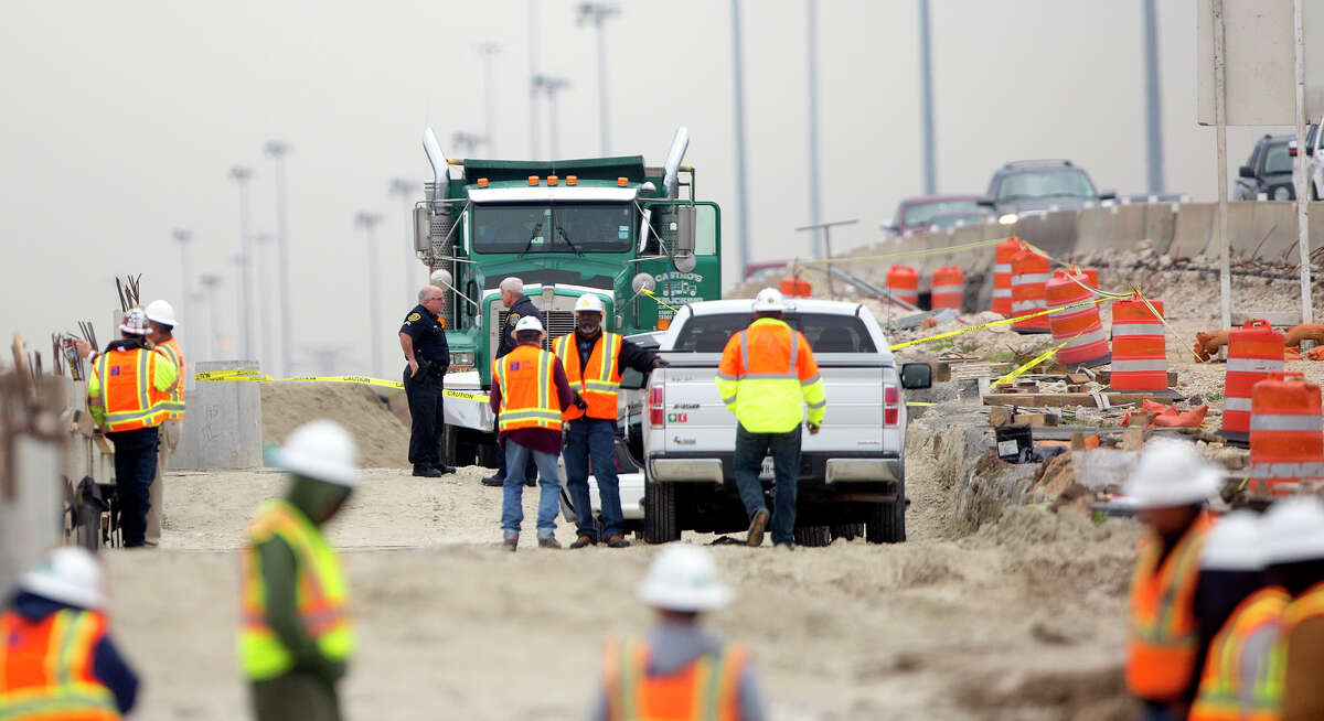 Authorities investigate a fatal accident involving a dump truck and a pedestrian Tuesday along the Northwest Freeway near Bingle.