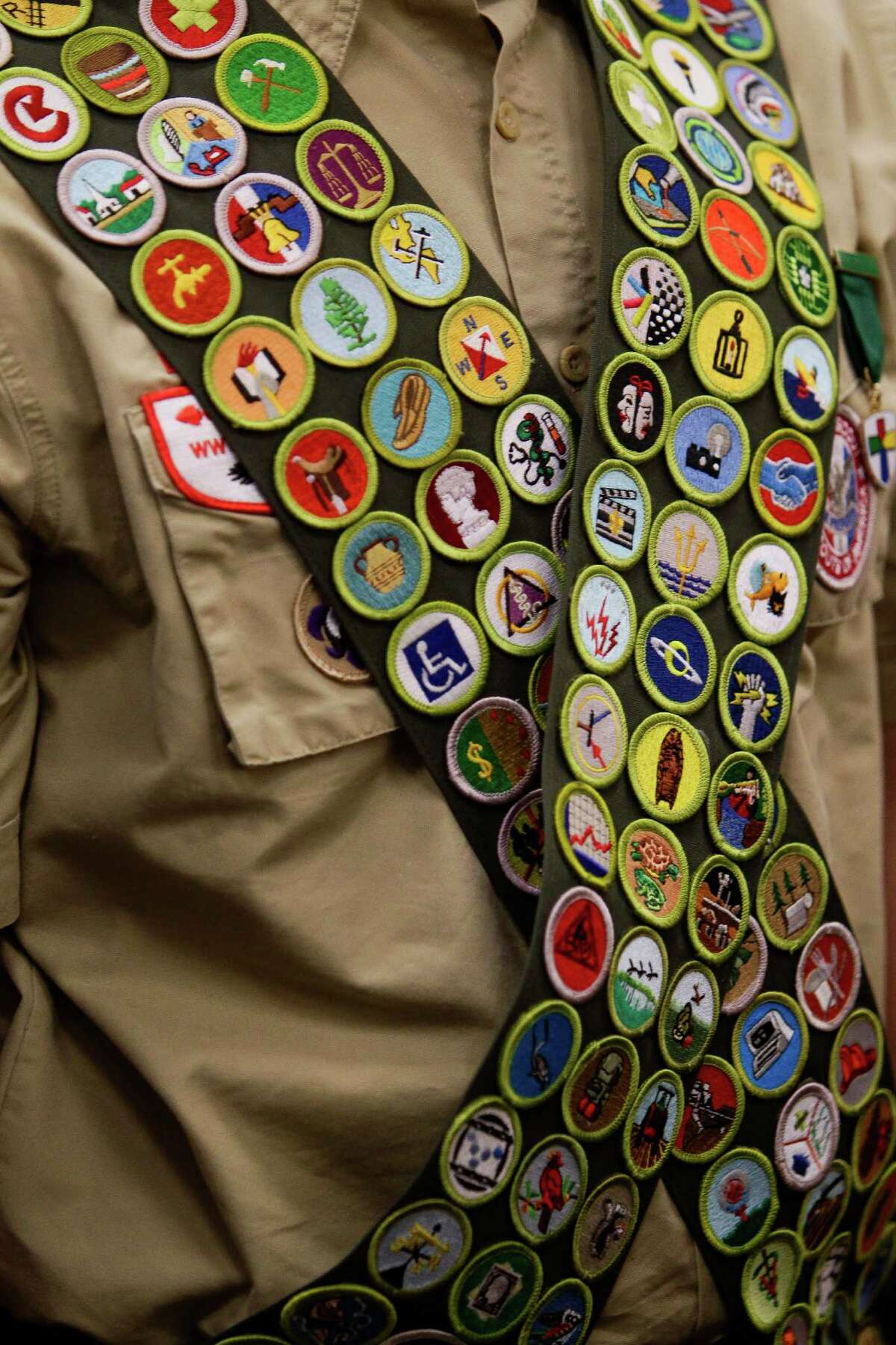 Eagle Scout John Gray, from Boy Scout Troop 599, walks back to his seat after receiving 18 merit badges and his second Gold Palm Tuesday, Jan. 26, 2016, in Houston as he earns all 138 merit badges offered by the Boy Scouts of America. By the troop's calculations, Gray is the 271st scout ever to earn all the possible badges.