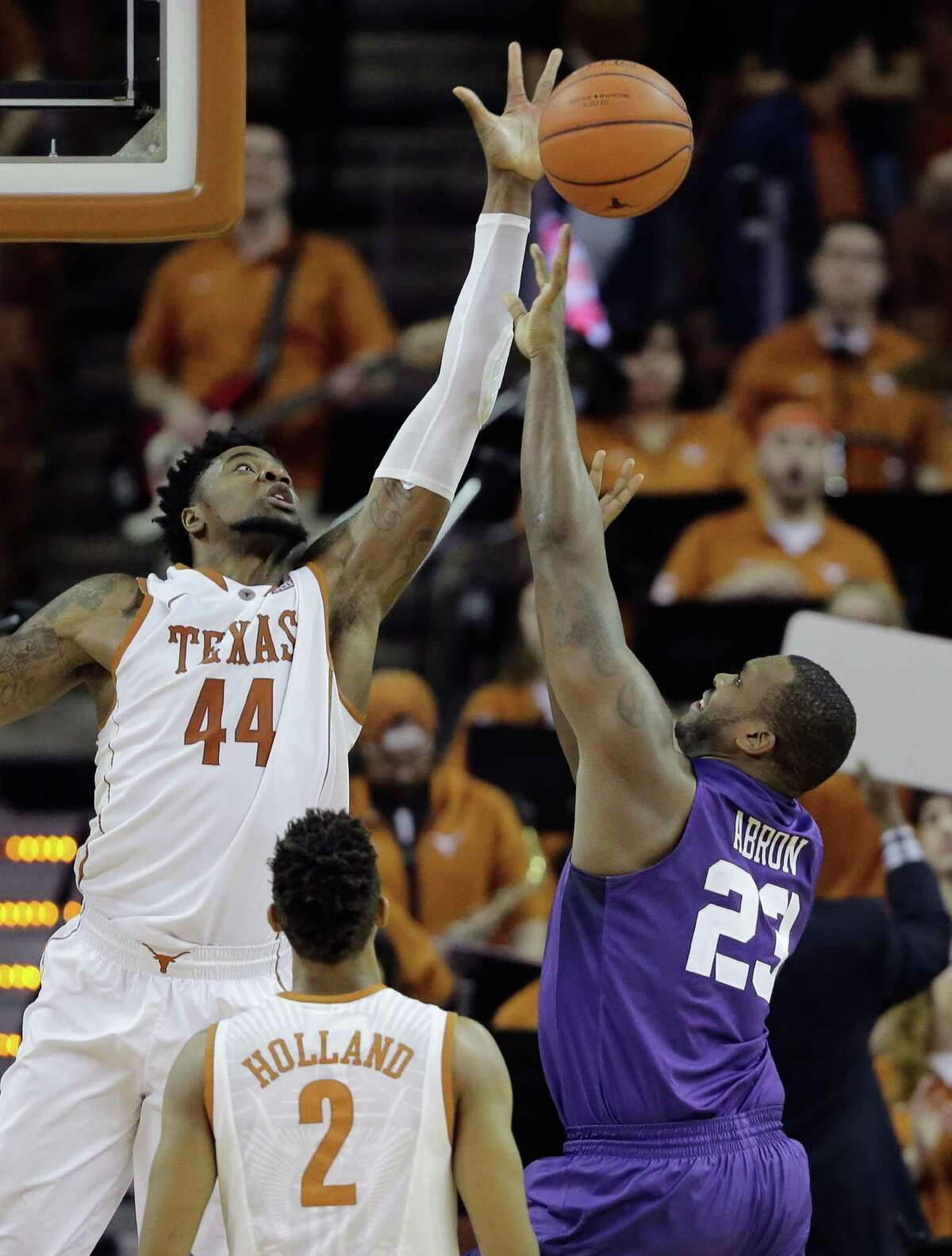 Texas' Prince Ibeh (44) adds a block of TCU's Devonta Abron to his 17-point, 10-rebound performance Tuesday night.