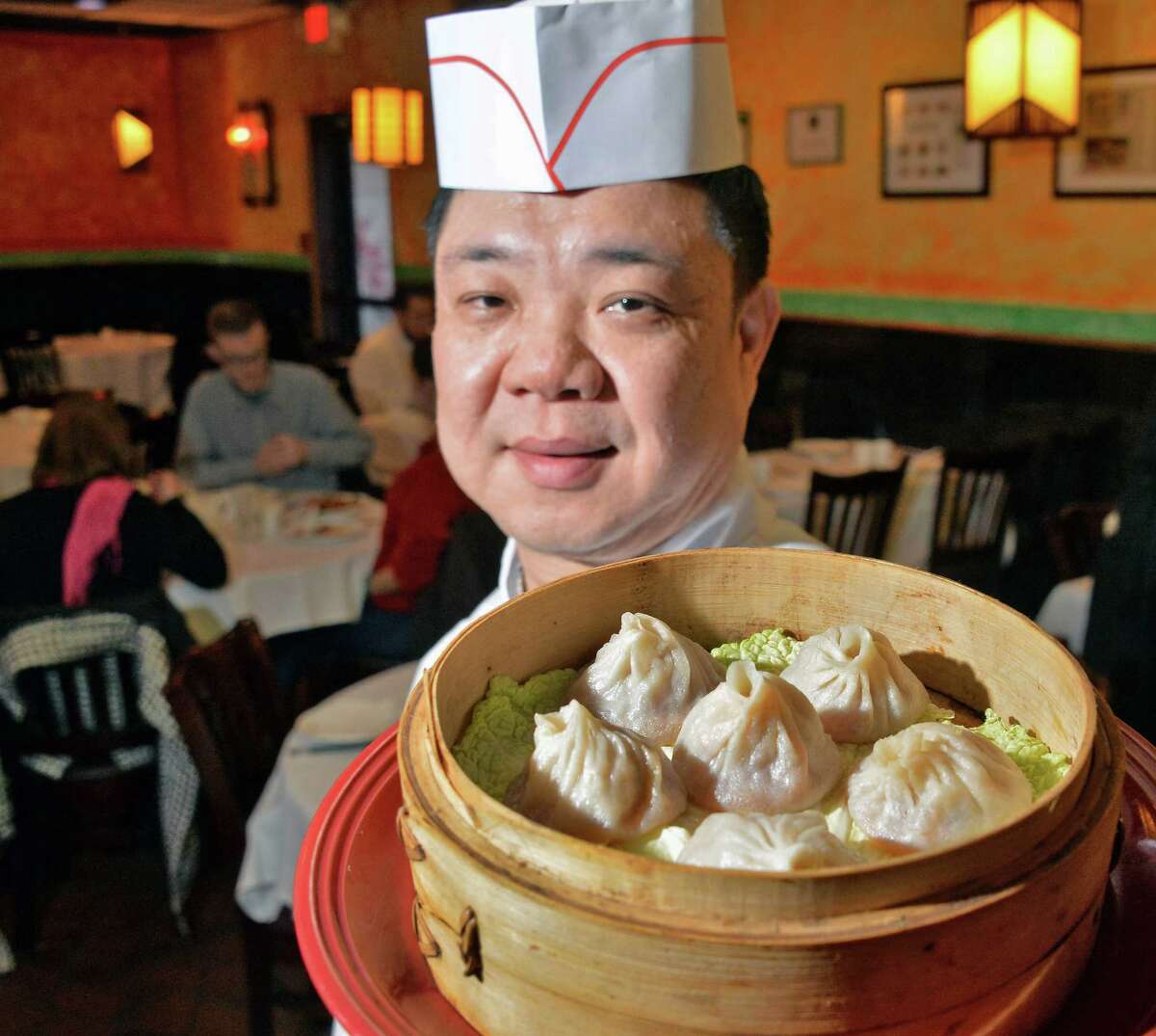 Head chef Qing Sheng Zhou with steamed pork soup dumplings at A la Shanghai Thursday Jan. 21, 2016 in Colonie, NY. (John Carl D'Annibale / Times Union)