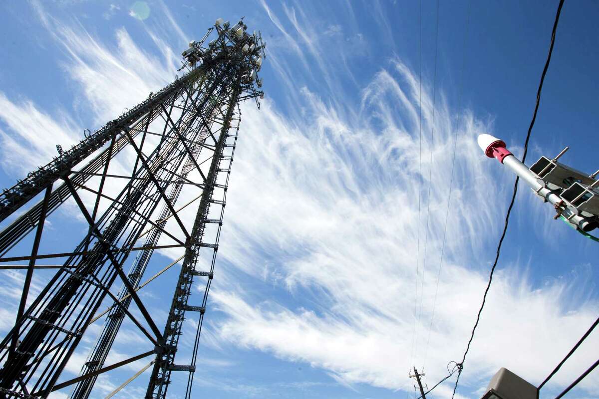 A traditional cell phone tower, owned by Crown Castle, is shown near the Texas Medical Center on Tuesday, Sept. 23, 2014, in Houston. ( Brett Coomer / Houston Chronicle )