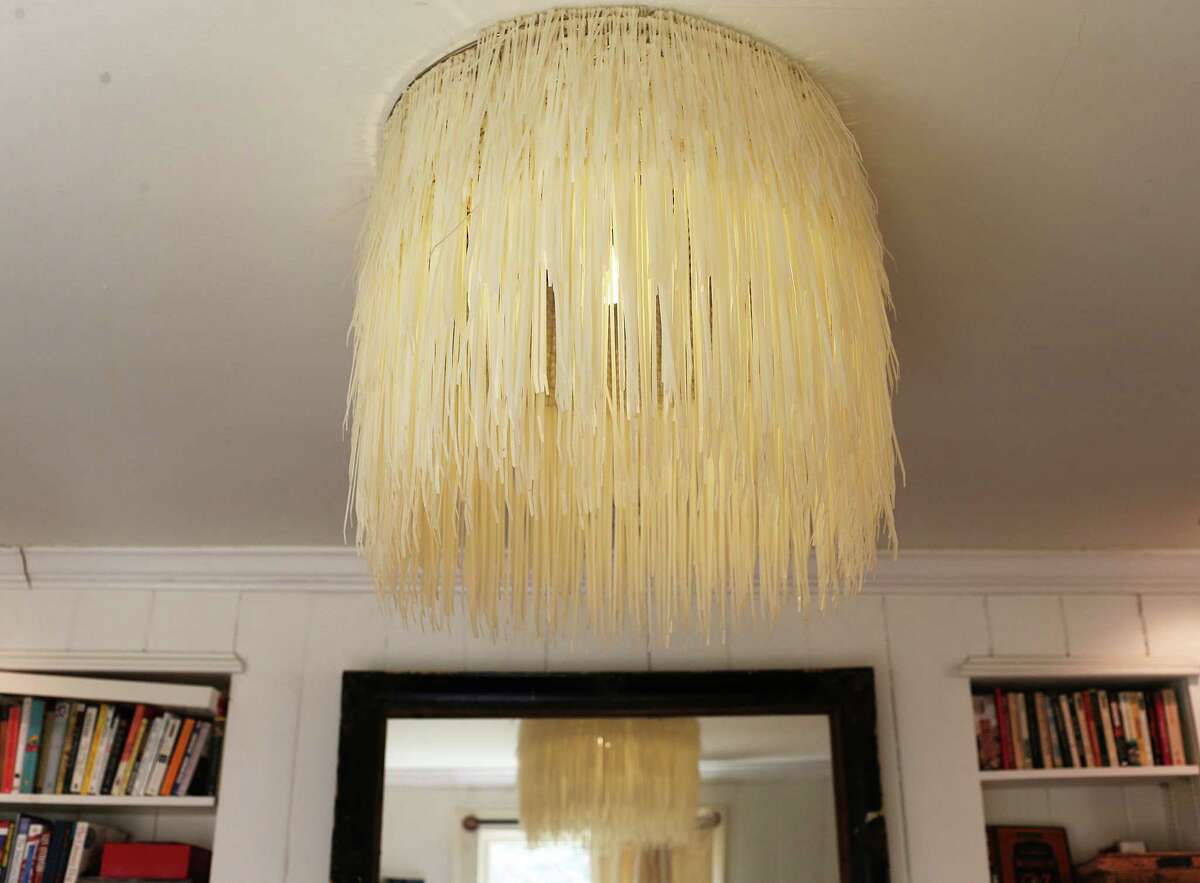 A chicken wire and zip ties chandelier is a feature in the Sullivans’ living room.