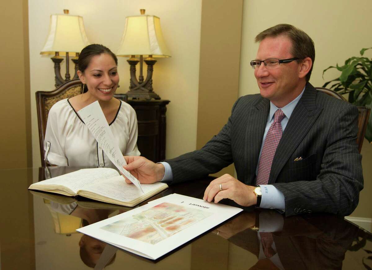Stewart Information Services Corporation CEO Mathew Morris talks with Escrow Officer Claudia Huerta on Monday, June 3, 2013, in Houston. ( J. Patric Schneider / For the Chronicle )