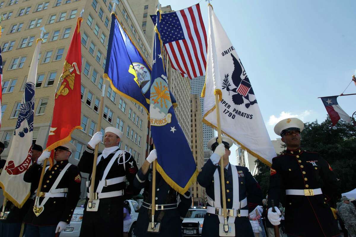 A joint military color guard readies to march along Texas Ave. during the Welcome Home Parade for Returning Iraq Veterans in downtown Saturday, April 7, 2012, in Houston. The event was sponsored by the City of Houston in partnership with the Astros 2012 opening weekend. ( Melissa Phillip / Houston Chronicle )