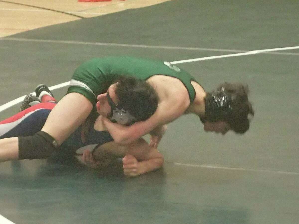 New Milford's Colin Lindner, top, pinned New Fairfield's Zach Kalmanson to win the 113-pound match and help lead the Green Wave to a 41-28 victory in their dual meet on Jan. 27, 2016.