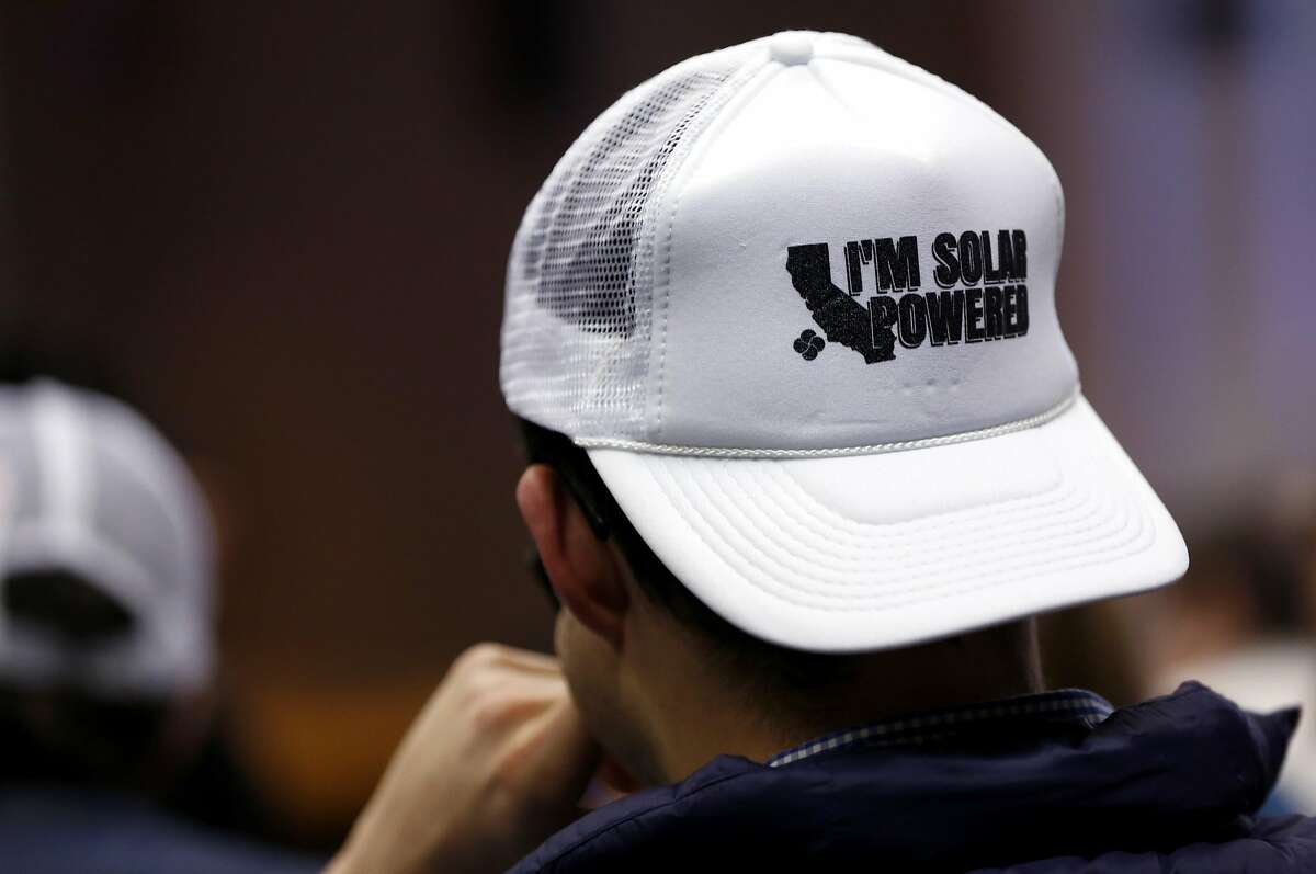 Ryan Gallentine wears a hat in support of solar energy during the California Public Utilities Commission meeting in San Francisco, California, on Thursday, Jan. 28, 2016.