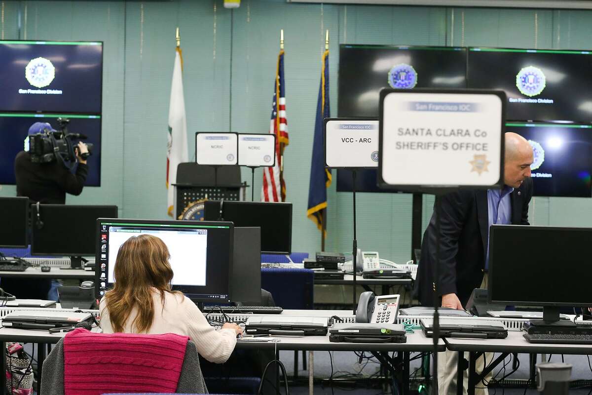 FBI personnel pose at computers at the FBI Super Bowl Joint Operation Center in Mountain View, Calif on Thursday, Jan. 28, 2016. The FBI Super Bowl Joint Operation Center will monitor the Bay Area the week of the Super Bowl