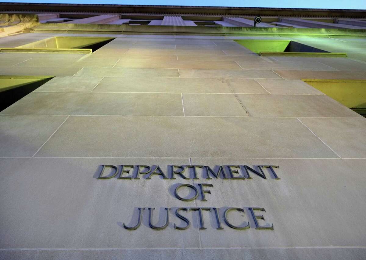 FILE - In this May 14, 2013, file photo, the Department of Justice headquarters building in Washington is photographed early in the morning.