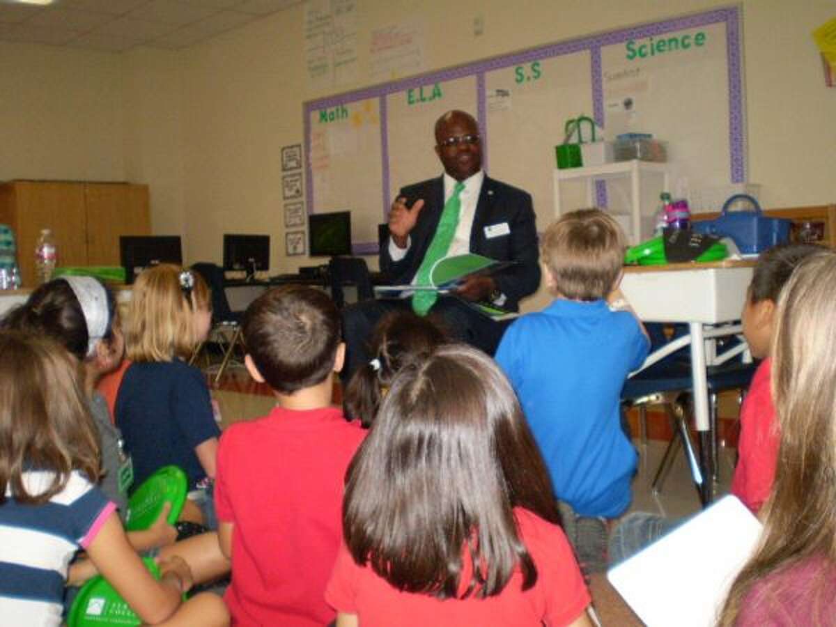 In this file photo, former Northeast Lakeview College President Craig Follins visits witha local second-grade class to talk about going to college. Follins has been reassigned, but Alamo Colleges officials will not say why.