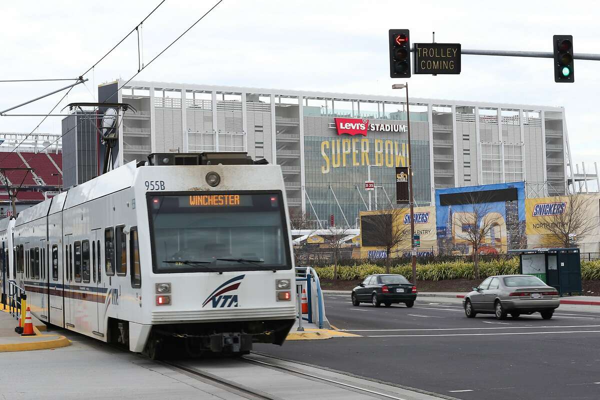 FILE -- A light rail train passes Levi's Stadium in Santa Clara, Calif. on Thursday, Jan. 28, 2016. Two people were killed Sunday afternoon after a light rail train struck a car in San Jose.
