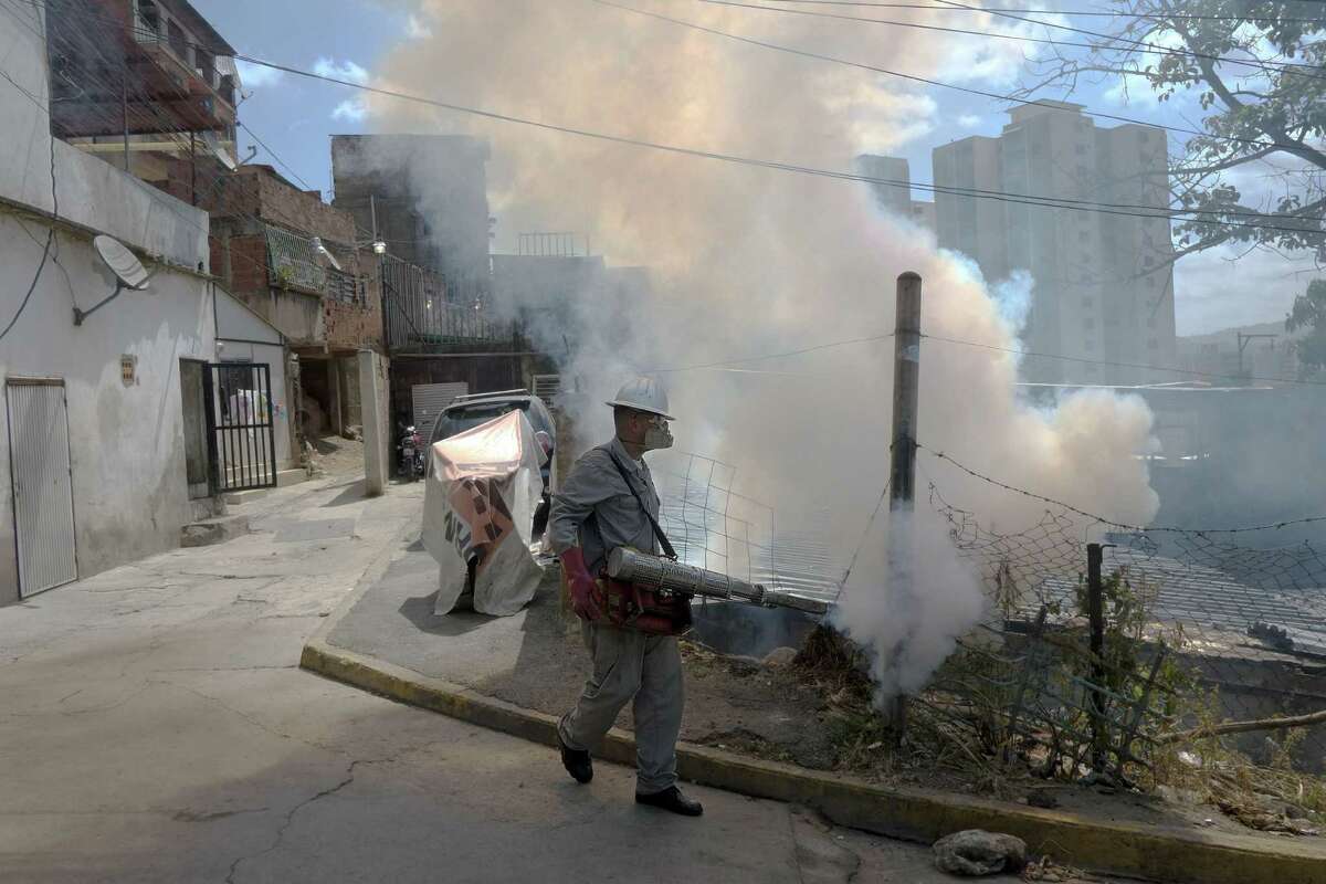 A Health Ministry employee fumigates against Aedes Aegypti mosquito, in Caracas on January 28, 2016. Venezuela has recorded 4,700 suspected cases of people infected by the Zika virus, which is thought to cause brain damage in babies, the health ministry said on Thursday. AFP PHOTO/JUAN BARRETOJUAN BARRETO/AFP/Getty Images