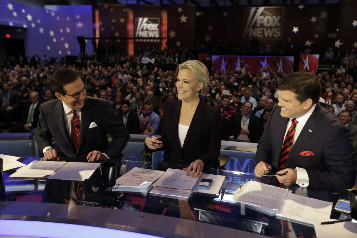 Moderators Chris Wallace, Megyn Kelly and Bret Baier smile as they wait for a Republican presidential primary debate, Thursday, Jan. 28, 2016, in Des Moines, Iowa. (AP Photo/Chris Carlson)
