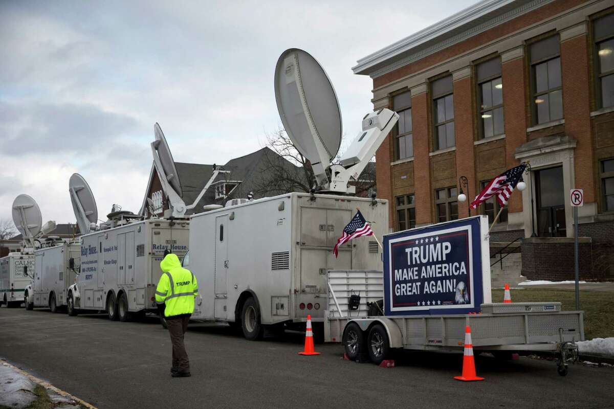 A trailer with a sign supporting Republican presidential candidate Donald Trump, and satellite trucks, are parked on the campus of Drake University in Des Moines, Iowa,Thursday, Jan. 28, 2016, where Trump is scheduled to hold a campaign event. (AP Photo/Jae C. Hong)