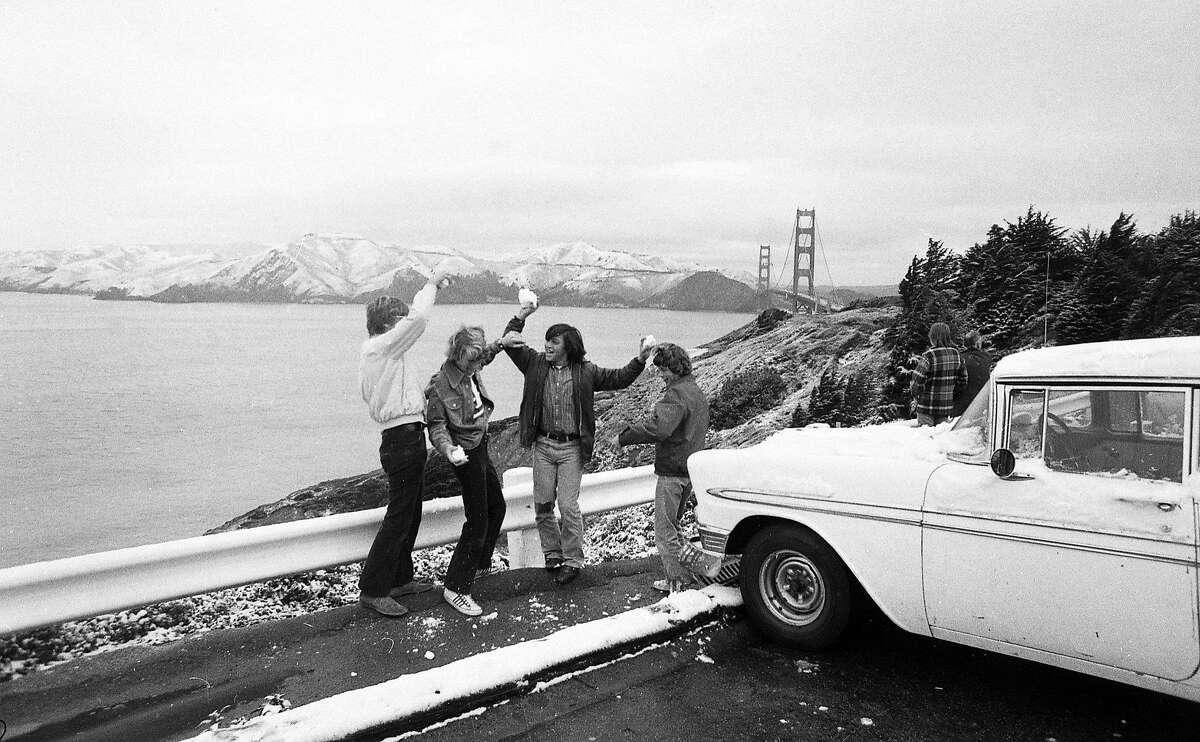 Feb. 5, 1976: Children play with snowballs in front of a beautiful view of the Golden Gate Bridge during a rare San Francisco snowfall in 1976.