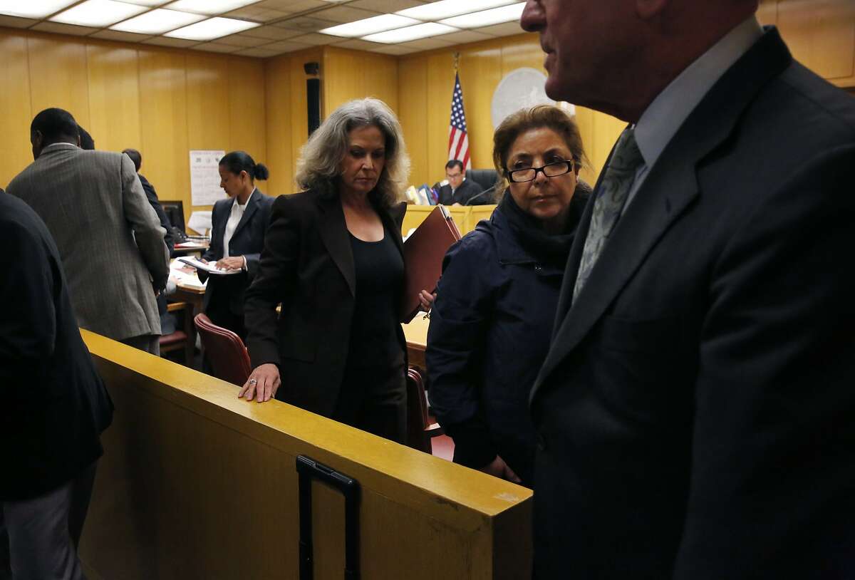 Nazly Mohajer, right center, walks back from appearing in front of a judge with Keith Jackson and Zula Jones Jan. 29, 2016 for an appearance in Superior Court for charges of accepting bribes for political favors in the Hall of Justice Building in San Francisco, Calif.