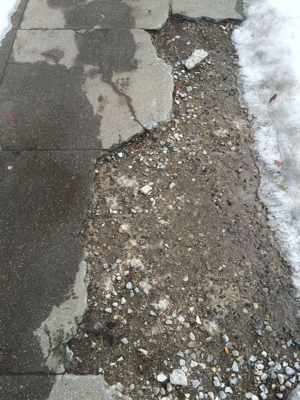 A section of cracked and damaged sidewalk along Main Street in in Bridgeport on Friday.
