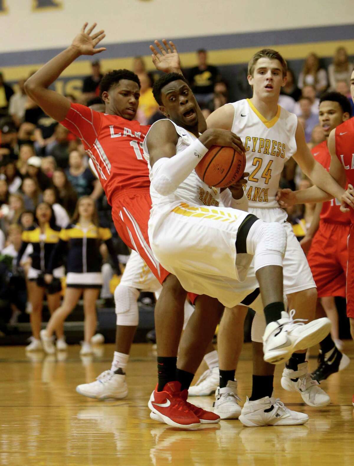 Anthony Agu (40), of Cypress Ranch, grabs a rebound in front of Jared Garcia (13), of Cypress Lakes, during the first quarter at Cypress Ranch High Friday, Jan. 29, 2016, in Cypress, Texas.