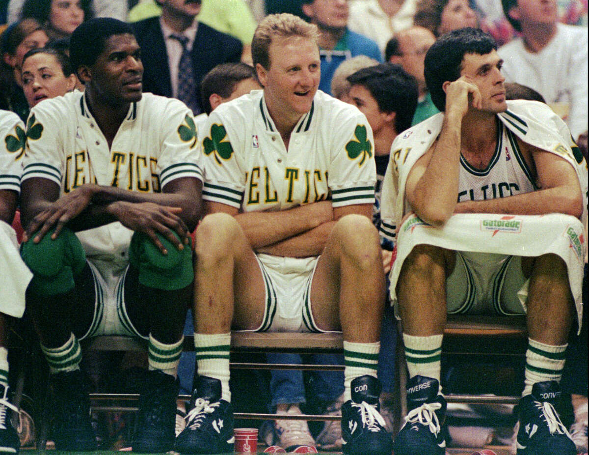 Boston Celtics stars (from left) Robert Parish, Larry Bird, and Kevin McHale watch their team win over the Washington Bullets at the Boston Garden on Nov. 30, 1991.