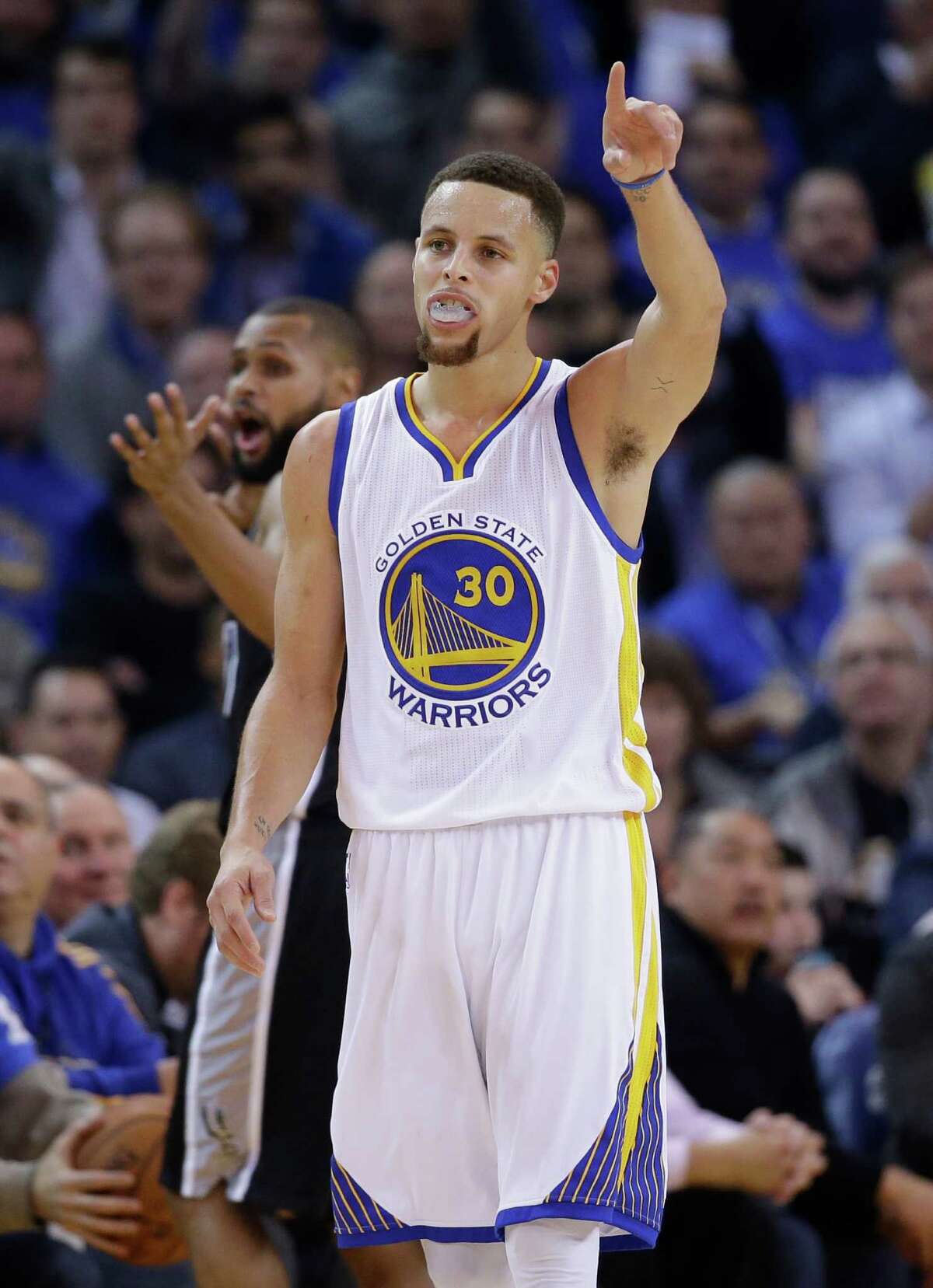 Golden State Warriors’ Stephen Curry celebrates a basket against the San Antonio Spurs on Jan. 25, 2016, in Oakland, Calif.