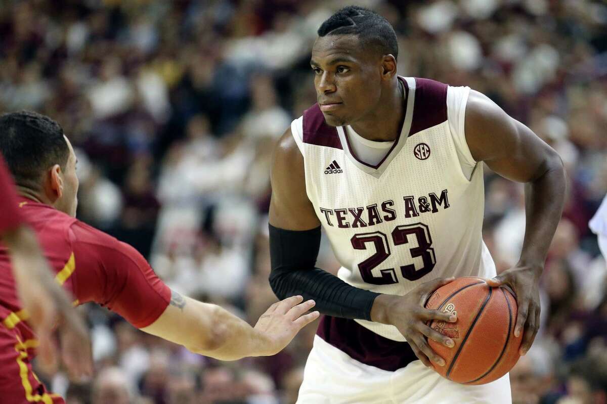 Texas A&M's Danuel House (23) looks to pass against Iowa State's Abdel Nader (2) during the first half of an NCAA college basketball game, Saturday, Jan. 30, 2016, in College Station, Texas. Texas A&M won 72-62. (AP Photo/Sam Craft)
