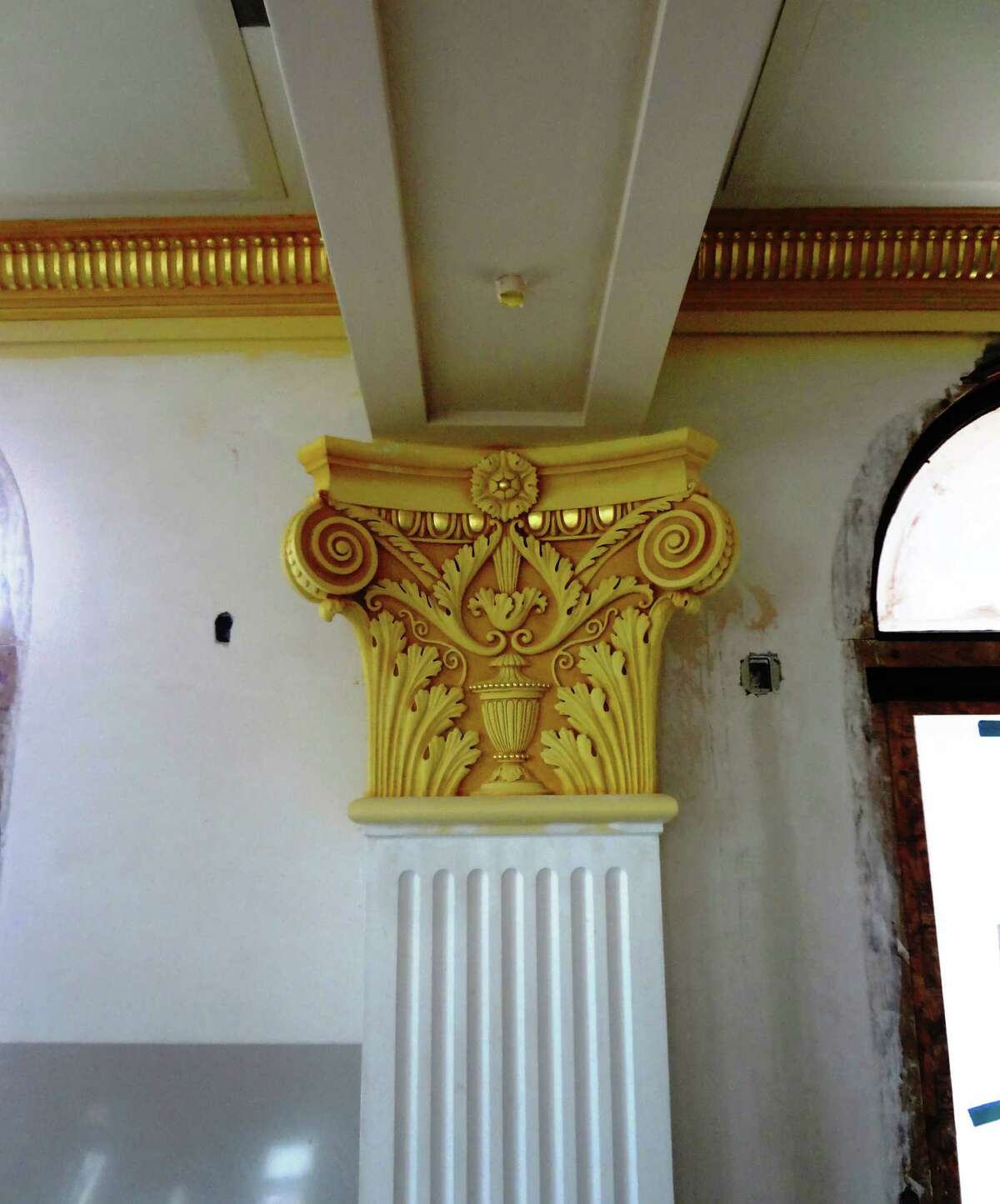 Restored column capitals in the double-height courtroom have a classical motif.