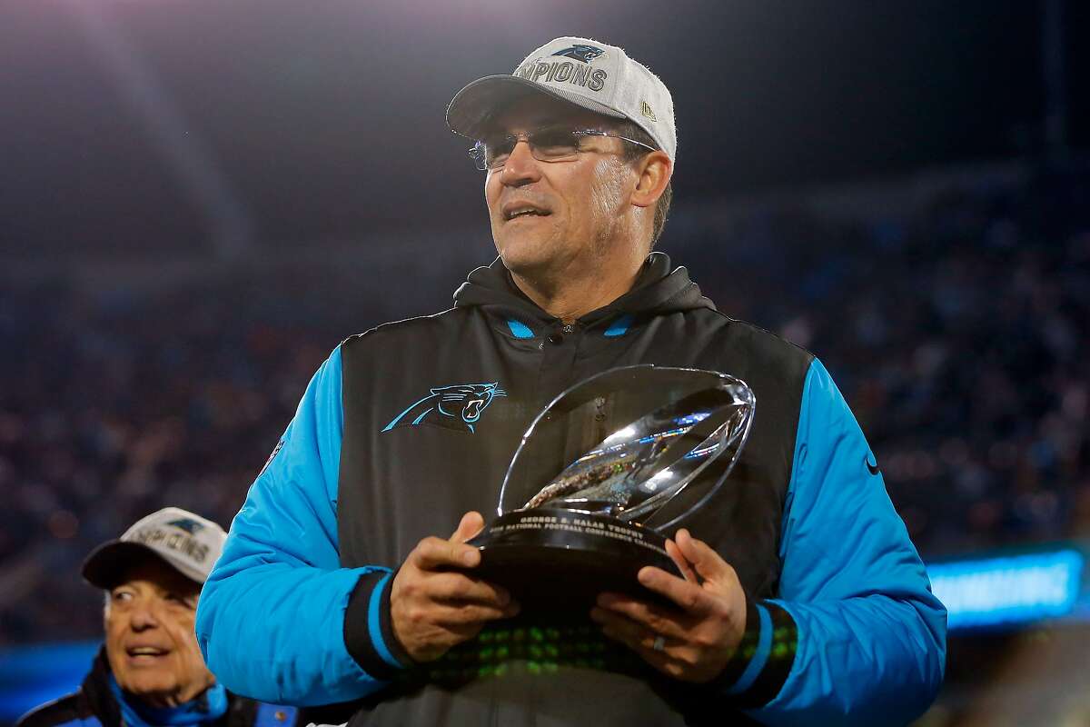 CHARLOTTE, NC - JANUARY 24: Head coach Ron Rivera of the Carolina Panthers celebrates with the George Halas Trophy after defeating the Arizona Cardinals with a score of 49 to 15 to win the NFC Championship Game at Bank of America Stadium on January 24, 2016 in Charlotte, North Carolina.