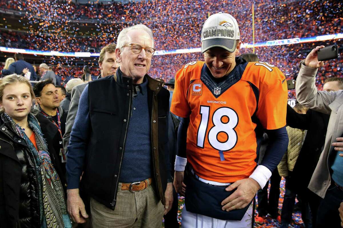 DENVER, CO - JANUARY 24: Peyton Manning #18 of the Denver Broncos and father Archie Manning walk off the field after defeating the New England Patriots in the AFC Championship game at Sports Authority Field at Mile High on January 24, 2016 in Denver, Colorado. The Broncos defeated the Patriots 20-18. (Photo by Doug Pensinger/Getty Images)