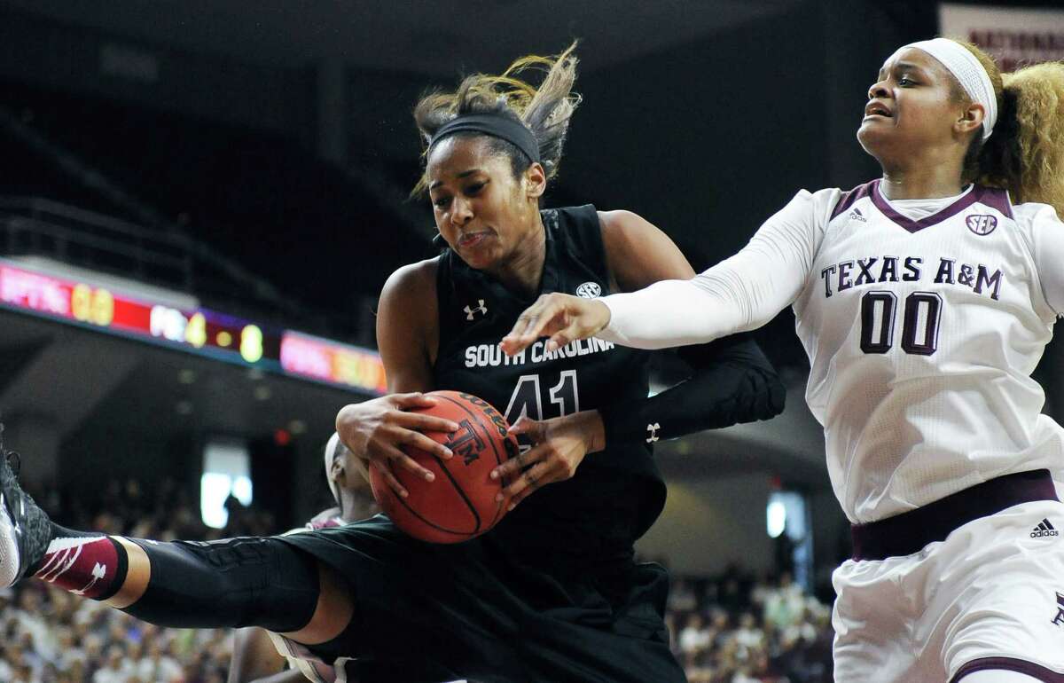 South Carolina's Alaina Coates (41) grabs a rebound from Texas A&M's Khaalia Hillsman (00) during the first half of an NCAA college basketball game Sunday, Jan. 31, 2016, in College Station, Texas. (AP Photo/Pat Sullivan)